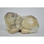 A modern, mottled white jade, carved as a recumbent Buddhist Lion looking to its left, 7 cm long;