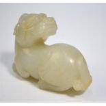 A modern Chinese, green jade of whitish hue, carved as a recumbent Buddhist Lion, looking over its