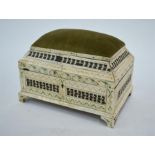 A Kholmogory style bone casket of stepped, rectangular form with a hinged cover, decorated on the