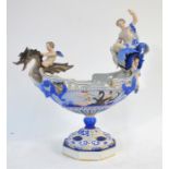 A Capodimonte porcelain centrepiece in the form of a boat with a dragon figure head ridden by a