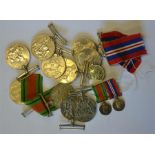 A quantity of WWII Defence (4) and 1939-45 War medals (7) to/w a miniature pair of same and a