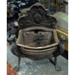 A 19th century bronze mounted cast iron fire basket, the shaped and relief decorated backplate