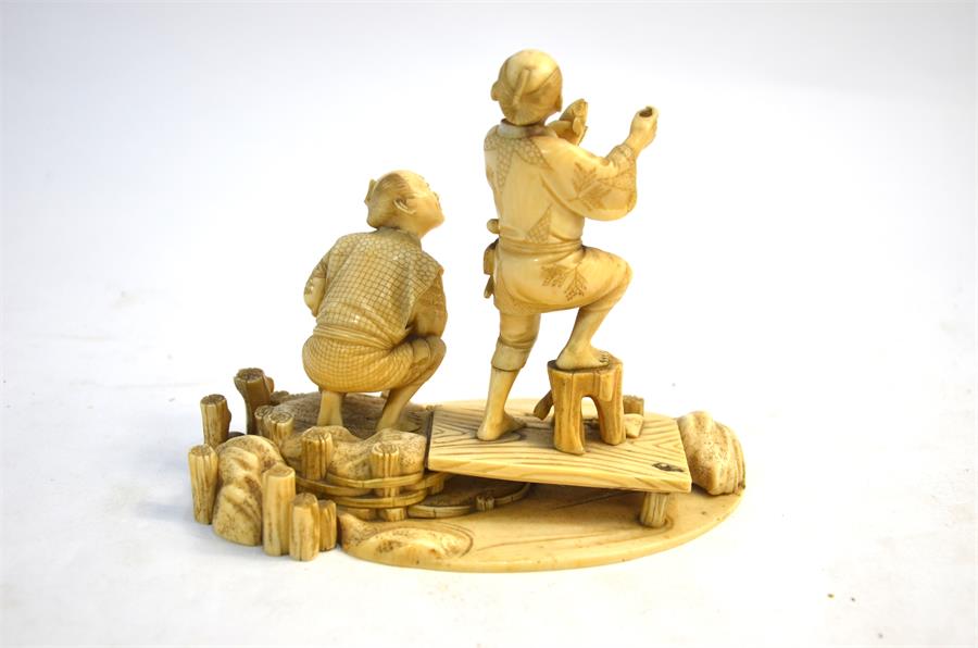 A Japanese, sectional ivory okimono, carved as two barefoot fishermen beside a stream, 14 cm wide, - Image 2 of 6
