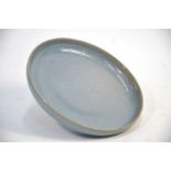 A modern Chinese Jun dish of circular form, decorated with a lavender, or other blue, glaze in the