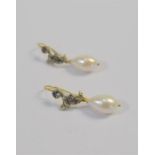 A pair of diamond and pearl drop earrings, the tear-shaped cultured pearl suspended from crescent