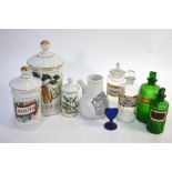 Collection of apothecary items including three porcelain Spanish jars, two green glass and two clear