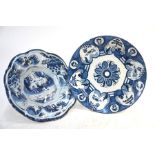 A Dutch Delft blue and white bowl of lobed form decorated in the Chinoiserie style with figures,