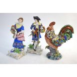 A pair of continental porcelain figures of a lady and gentleman both carrying a basket of flowers,