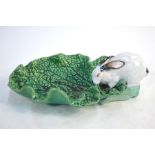 A Victorian Minton majolica cabbage leaf dish with handle in the form of a white rabbit, impressed