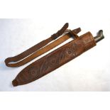 A machete with horn handle and leather scabbard