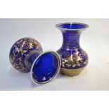 A matched pair of early 19th century Bristol blue glass vases with unusual opaque twist rims,