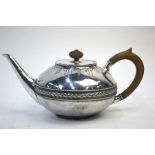 Liberty & Co. - A planished silver teapot of compressed form with vine engraving and woven design