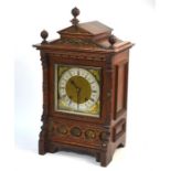 A 19th century German oak architectural cased 8-day mantel clock, the two train movement striking on