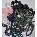 A large collection of various stone bead necklaces, including quartz, agate, lapis lazuli etc