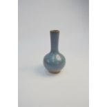 A modern Chinese Jun style vase with cylindrical neck and a single mottled crimson splash in the