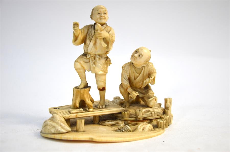 A Japanese, sectional ivory okimono, carved as two barefoot fishermen beside a stream, 14 cm wide, - Image 4 of 6