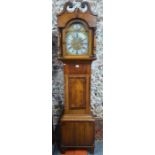 A 19th century oak and satinwood longcase clock, the 8-day movement with arched brass dial and