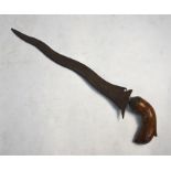 An antique Indonesian kris dagger with 30 cm laminated wavy blade and carved wood handle (lacks