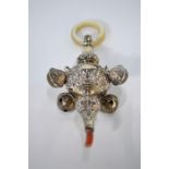 An Edwardian silver baby's rattle with four bells and mother-of-pearl ring (coral teether a/f),