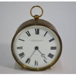 A brass drum cased clock with eight-day lever escapement movement and white enamelled dial signed