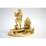 A Japanese, sectional ivory okimono, carved as two barefoot fishermen beside a stream, 14 cm wide,