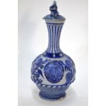 A 19th century German stoneware salt-glazed bottle vase and cover with dwarf finial, the body