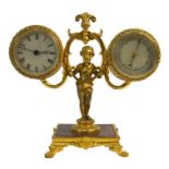 A gilt brass desk clock/barometer with twin drum cases supported by a putto, on square base with