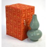 A modern, pale celadon Chinese vase of gourd form; the base with five spur marks, 15 cm high No