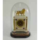 A 19th century alabaster mantel clock, surmounted by a gilt spelter lion, the blue/gilt dial flanked