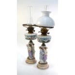 A pair of Dresden oil lamps, 19th century, the oil well moulded with Neptune, Salacia, dolphins
