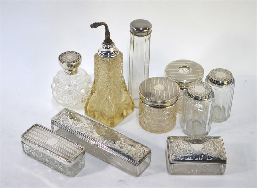 Ten various silver-topped cut glass toiletry bottles, jars and boxes including two scent bottles (