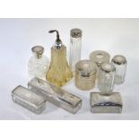 Ten various silver-topped cut glass toiletry bottles, jars and boxes including two scent bottles (