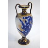 A Royal Doulton Burslem twin handle vase decorated with blue irises on a mottled gilded ground, 22.5