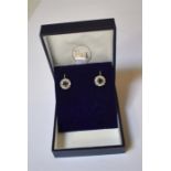 A pair of synthetic blue sapphire and white sapphire cluster earrings, the central circular blue