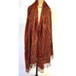 A wool mix Kashmir style shawl with fringed ends, deep red/peach paisley design and a wool mix