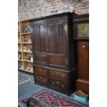 An 18th century oak joint cupboard with panelled doors over two short and two short drawers,