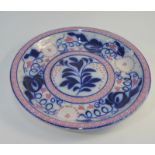 A large continental circular tin glazed shallow bowl, earl 20th century, blue and pink floral and