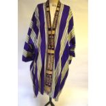 A Middle Eastern style robe with wide purple/green stripe and metal thread-work to front and a