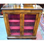 A Victorian satinwood inlaid mahogany cabinet with gilt metal mounts, the two glazed doors opening