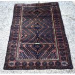 An Afghan Mushwani Baluch rug, circa 1900, the navy radiating diamond with brown ground and