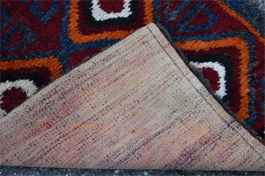 A Julkhyrs rug, circa 1900, the thick wool pile with wine ground and orange diamond design with blue - Image 3 of 3
