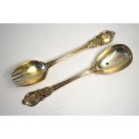 A late Victorian heavy quality pair of silver servers with ornate cast handles, Holland