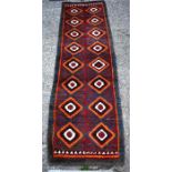 A Julkhyrs rug, circa 1900, the thick wool pile with wine ground and orange diamond design with blue