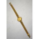 A lady's 9ct Bueche-Girod wristwatch with circular dial flanked by diamond-set shoulders and fancy