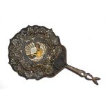 A mid 19th century Javanese rigid fan made from pierced water buffalo skin, painted in gold and