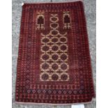 An Afghan Baluch prayer rug, circa 1900, the repeating gold design on a camel ground with