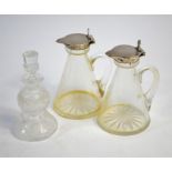 A pair of conical glass whisky noggins with star-cut bases and hinged collars and covers, John