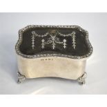 An Edwardian silver, tortoiseshell and piqué-work serpentine-form trinket box with hinged cover