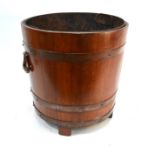 A large copper bound coopered log bucket with tin liner, two handles and four stave feet, 45 cm diam