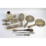 A quantity of silver-mounted dressing table items, including toilet jars, tortoiseshell-mounted